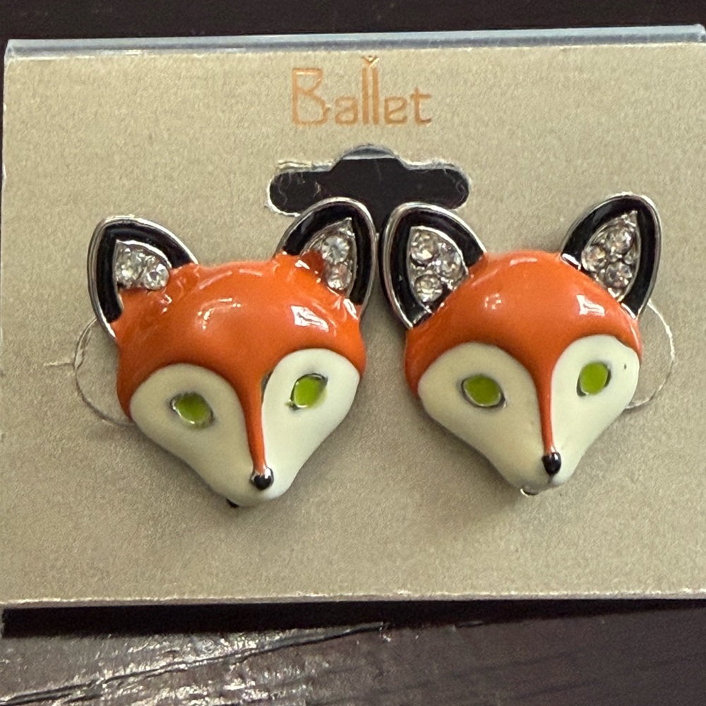 Ballet brand fox-shaped studs featuring orange and white enamel crystal